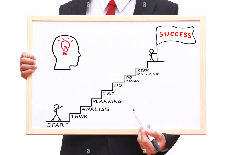 Manufacturing founder walking factory floor with next generation leader discussing operations