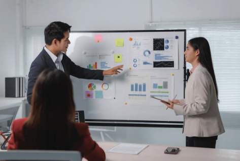 Executive team reviewing operations on a manufacturing plant floor after acquisition