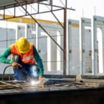 Manufacturing leadership team in a group coaching session on plant floor